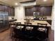 Spacious kitchen featuring dark cabinetry, stainless steel appliances, and a large center island with seating at 1211 Chapel Estates Way, Dacula, GA 30019