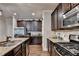 Kitchen with stainless steel appliances, granite countertops, and beautiful wood floors at 1211 Chapel Estates Way, Dacula, GA 30019