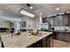 Spacious kitchen with a large island with a double sink and granite countertops for cooking at 1211 Chapel Estates Way, Dacula, GA 30019