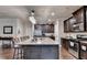Eat-in kitchen features dark cabinets, stainless steel appliances, and granite counters at 1211 Chapel Estates Way, Dacula, GA 30019