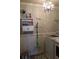 Well-organized laundry room with storage, modern appliances and chandelier at 1211 Chapel Estates Way, Dacula, GA 30019