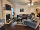 Cozy living room features hardwood floors, an inviting fireplace, and comfortable seating, creating a warm atmosphere at 1211 Chapel Estates Way, Dacula, GA 30019