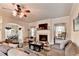 Bright living room with a fireplace, a TV, and an open-concept design that flows into the adjacent dining area at 1211 Chapel Estates Way, Dacula, GA 30019