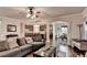 Open-concept living area with hardwood flooring, a sectional sofa, and recessed lighting at 1211 Chapel Estates Way, Dacula, GA 30019