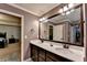 Stylish bathroom features a large mirror, double sink vanity, tiled floors, and access to bedroom at 1211 Chapel Estates Way, Dacula, GA 30019
