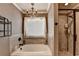 Stylish bathroom features a soaking tub, tiled floors, tile surround, and glass enclosed shower at 1211 Chapel Estates Way, Dacula, GA 30019
