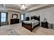 Spacious main bedroom features tray ceilings, carpet, and stylish ceiling fan with elegant light fixture at 1211 Chapel Estates Way, Dacula, GA 30019
