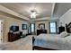 Spacious main bedroom featuring tray ceiling, chandelier, and stylish furniture at 1211 Chapel Estates Way, Dacula, GA 30019
