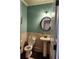 Charming powder room with updated light fixture, vanity, and wainscotting at 1211 Chapel Estates Way, Dacula, GA 30019