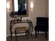 Vanity with a decorative mirror, lighting fixtures, and a chair; creating a cozy getting-ready space at 1211 Chapel Estates Way, Dacula, GA 30019