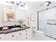 Updated bathroom featuring a tiled shower, black countertop, and updated fixtures at 3064 Chastain Park Ne Ct, Atlanta, GA 30342