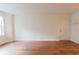 Spacious room featuring hardwood floors and a bright white entry door at 3064 Chastain Park Ne Ct, Atlanta, GA 30342