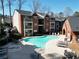 Aerial view of a sparkling community pool and lounge area in an apartment complex at 3064 Chastain Park Ne Ct, Atlanta, GA 30342