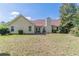 Backyard featuring green grass and the back of the house with a grill at 320 Creekside Trl, Covington, GA 30016