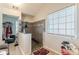 A bathroom featuring a walk in shower, window, and tile floors at 320 Creekside Trl, Covington, GA 30016