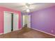 Bedroom with colorful walls, carpet, and a closet at 320 Creekside Trl, Covington, GA 30016