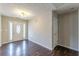 Bright foyer featuring wood floors, a textured ceiling, and a stylish front door with glass at 320 Creekside Trl, Covington, GA 30016