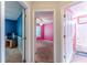 Hallway featuring entrances to a blue room, bedroom, and a pink bathroom at 320 Creekside Trl, Covington, GA 30016