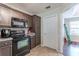 A kitchen with stainless steel appliances and access to a door at 320 Creekside Trl, Covington, GA 30016