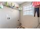 Compact laundry room with shelving, connections, and a window for natural light at 320 Creekside Trl, Covington, GA 30016