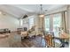 Cozy living room with a dining area featuring hardwood floors and a fireplace at 320 Creekside Trl, Covington, GA 30016