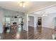 Open-concept living room with hardwood floors, fireplace, and access to the kitchen at 320 Creekside Trl, Covington, GA 30016