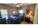 Bright bedroom with a large window, a bed with blue bedding, and a simple decor at 275 Bridgemill Dr, Douglasville, GA 30134