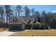 Charming home featuring a two-car garage, stone accents, and a well-maintained front yard at 275 Bridgemill Dr, Douglasville, GA 30134