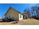 Rear view of a light yellow home featuring an outdoor patio and well-maintained lawn at 275 Bridgemill Dr, Douglasville, GA 30134
