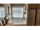 Clean main bathroom features a soaking tub, a shower with glass doors, and neutral colored walls at 275 Bridgemill Dr, Douglasville, GA 30134