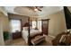Spacious main bedroom with tray ceilings, a decorative bed frame and a barn door to the ensuite bathroom at 275 Bridgemill Dr, Douglasville, GA 30134