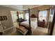 Bright main bedroom with a decorative bed frame, neutral walls, and a barn door to the ensuite bathroom at 275 Bridgemill Dr, Douglasville, GA 30134