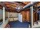 Unfinished basement with exposed ceiling, stairs and supports, showing potential for customization and storage at 17 Peachtree Ne Ave, Atlanta, GA 30305