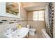 Bathroom with a single sink, toilet, shower/tub, and tiled walls at 17 Peachtree Ne Ave, Atlanta, GA 30305