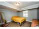 Bedroom featuring wood-look floors, modern lighting, a yellow bedspread and a mirror at 17 Peachtree Ne Ave, Atlanta, GA 30305