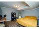 Bedroom featuring wood-look floors, modern lighting, a yellow bedspread and a bookshelf at 17 Peachtree Ne Ave, Atlanta, GA 30305