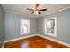 Light-filled bedroom with hardwood floors, neutral walls, and bright windows at 17 Peachtree Ne Ave, Atlanta, GA 30305