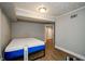 Bedroom featuring wood-look floors, modern lighting and a blue and white mattress at 17 Peachtree Ne Ave, Atlanta, GA 30305
