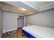 Bedroom featuring wood-look floors, modern lighting and a blue and white mattress at 17 Peachtree Ne Ave, Atlanta, GA 30305