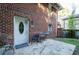 Brick home exterior with front door and small patio area showing the outdoor space at 17 Peachtree Ne Ave, Atlanta, GA 30305