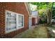 Close up view of a brick home showcasing the window details and landscaping at 17 Peachtree Ne Ave, Atlanta, GA 30305
