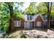 Charming brick home featuring large windows and mature trees in a peaceful neighborhood at 17 Peachtree Ne Ave, Atlanta, GA 30305