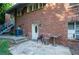 Brick home exterior with front door and small patio area, showing curb appeal and outdoor seating at 17 Peachtree Ne Ave, Atlanta, GA 30305