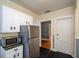 Kitchen with stainless steel refrigerator, microwave and white cabinets at 17 Peachtree Ne Ave, Atlanta, GA 30305