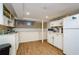 Kitchen featuring white cabinets, white refrigerator, and white appliances at 17 Peachtree Ne Ave, Atlanta, GA 30305