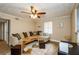 Living room featuring a large sectional sofa, ceiling fan, and natural lighting, perfect for relaxing and entertaining at 17 Peachtree Ne Ave, Atlanta, GA 30305