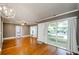 Bright living room with hardwood floors, recessed lights, a chandelier, and large windows at 17 Peachtree Ne Ave, Atlanta, GA 30305