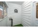 Enclosed porch area with white painted walls, trim and an arched window at 17 Peachtree Ne Ave, Atlanta, GA 30305