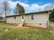 Backyard featuring a small deck, manicured grass and a newly painted exterior at 1793 Witt Cir, Austell, GA 30168