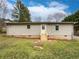 Backyard featuring a small deck, manicured grass and a newly painted exterior at 1793 Witt Cir, Austell, GA 30168